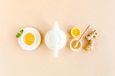 Herbal tea with mint, ginger, lemon, honey and other herbs on yellow background Stock Photos