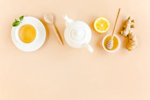 Herbal tea with mint, ginger, lemon, honey and other herbs on yellow background Stock Photos