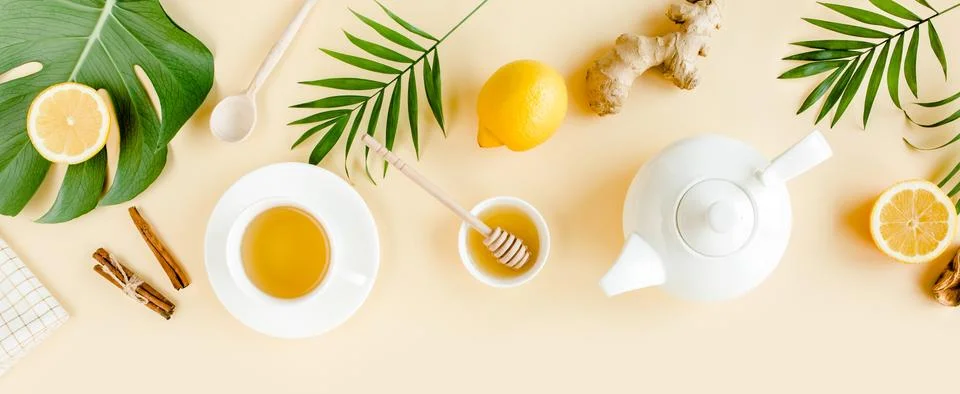 Herbal tea with mint, ginger, lemon, honey and other herbs on yellow background Stock Photos
