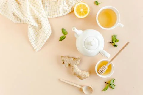 Herbal tea with mint, ginger, lemon, honey and other herbs on yellow background Stock Photos