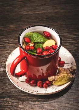 Herbal tea in red mug Stock Photos