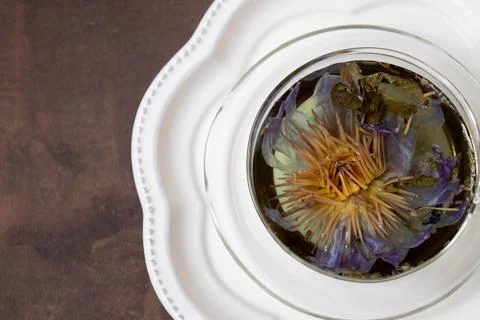 Herbal tea in rustic tea cup on White background Stock Photos