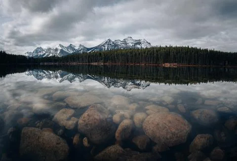Herbert lake in Alberta, Canada on a cloudy day with stunning mountains and Stock Photos