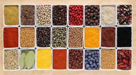 Herbs and spices in rectangular ceramic containers. Stock Photos