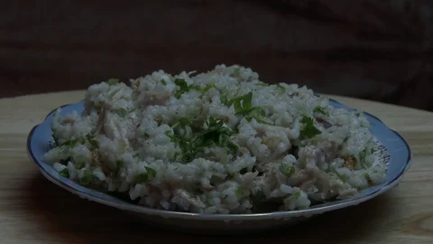 Herbs fall on boiled rice and chicken meat Stock Footage 78591058