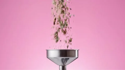 Herbs falling into bottle through the funnel Stock Footage 145791330