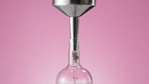 Herbs falling into bottle through the funnel Stock Footage 145791549