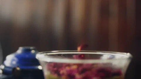 Herbs falling into a jug with tea Stock Footage 274694318