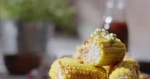 Herby Butter Slowly Melts On Stack of Golden Grilled Sweet Corn On The Cob Video stock 161954370