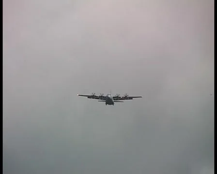 Hercules C130 flying towards the camera, dips into Khe San Approach-DV PAL Stock Footage 1044064