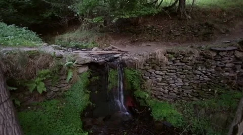 Herd of goats crossing a river with a small waterfall.Time Lapse Stock Footage 54271776