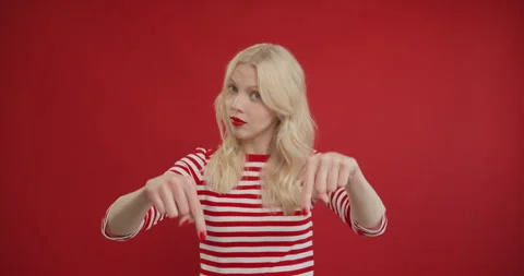 Here and right now. Young woman pointing fingers down, demanding to come Stock Footage 150973429
