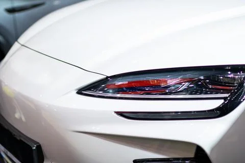 Here is a close up image showcasing a white cars headlight clearly Stock Photos