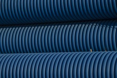 Here is a close up photograph showing a stack of blue plastic pipes Stockfoto's