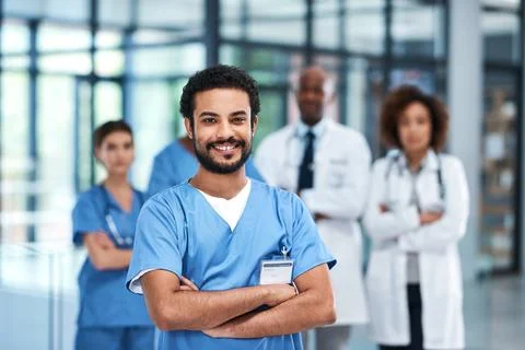 Here to help you get better. Portrait of a young medical practitioner standing Stock Photos