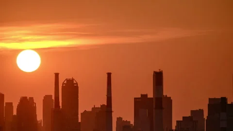 Here is the sun setting over a power generating station in LIC. Stock Footage 341363295