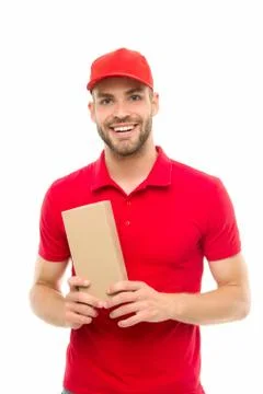 Here is your parcel. Ready to serve you. Man delivery service. Guy in red cap 写真素材