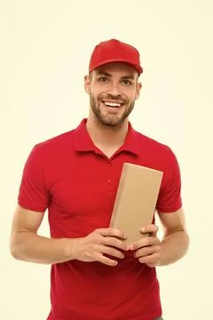 Here is your parcel. Ready to serve you. Man delivery service. Guy in red cap Stock Photos