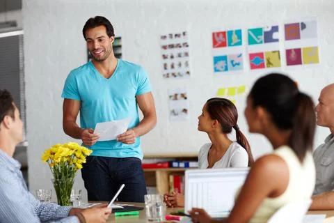 Heres that document you requested. A group of businesspeople discussing work. Stock Photos
