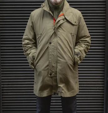 Heritageinspired olive parka with practical design and cozy seasonality Stock Photos