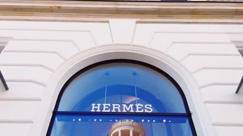 Hermes logo displayed at boutique storefront, fashion and leather goods brand Stock Footage 139821995