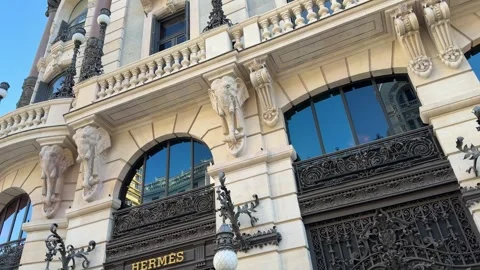 Hermes storefront stands within richly decorated stone building as camera p.. Stock Footage 347596836