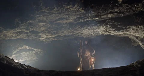 Hermit with lamp entering cave Video stock 168807484