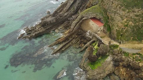 Hermitage built in a cliff hole near the sea Stock Footage 166199944