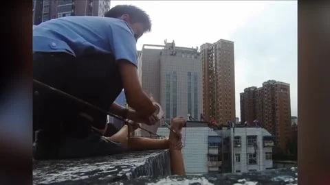 Hero Cop Handcuffs Himself To Suicidal Man Atop Building Ledge In Shiyan, Hu... Stock Footage 249887028