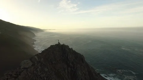 Hero Stands on Seaside Cliff  - Conquer Life Stock Footage 87716635