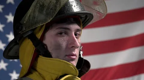 Heroic firefighter in front of US flag 動画素材 10945127