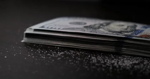 Heroin or cocaine powder on stack of hundred dollar bills, close up Stock Footage 233453101