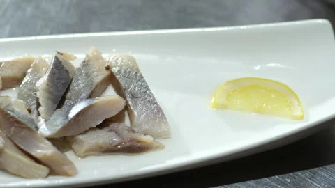Herring with onions Fish rolls with sour herring on green plate Stock Footage 313395361