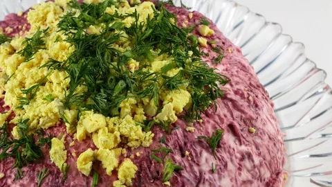 Herring under a fur coat,a large portion on a transparent plate. Stock Footage 129069291