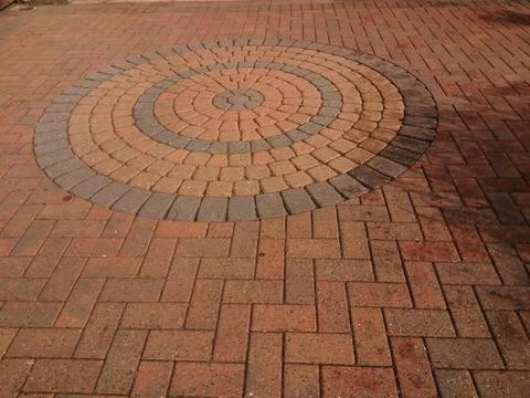 Herringbone block paving with circle design in a low maintenance garden Stock Photos