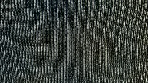 Herringbone knit fabric texture macro closeup reveals dark vertical ribbed se Stock Photos