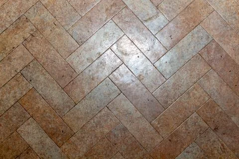 Herringbone pattern beige stone tile floor texture for interior design Stock Photos