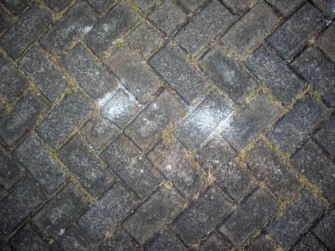 A herringbone pattern of bricks on the sidewalk Stock Photos