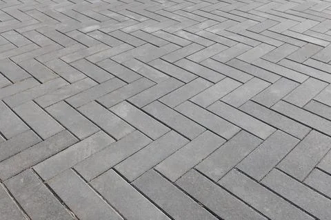 Herringbone pattern of gray concrete pavers, urban background 写真素材