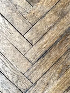 Herringbone pattern wooden floor with light brown planks showcasing natural Stock Photos