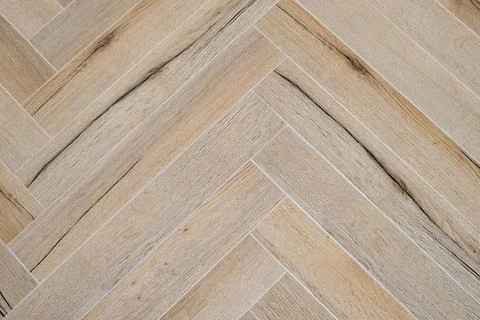 Herringbone patterned floor created by lying rectangular tile blocks Stock Photos