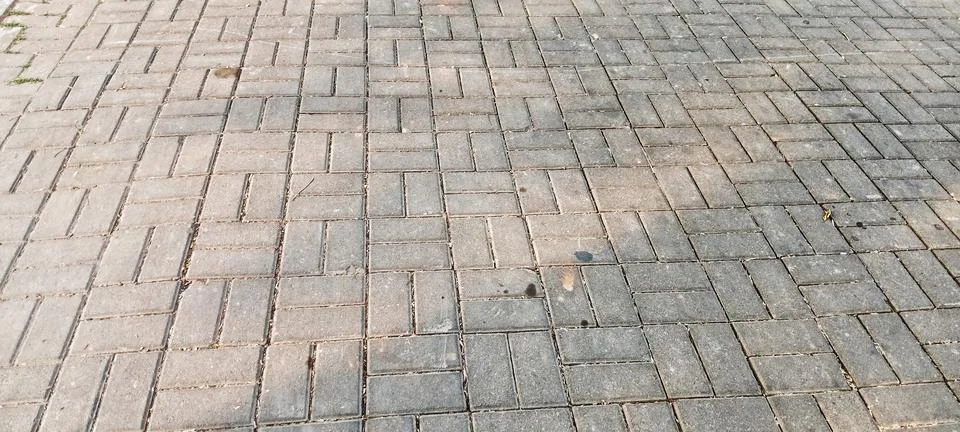 Herringbone-patterned paving block texture Stock Photos