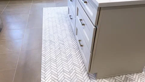 Herringbone Tile Pattern Meets Smooth Tan Flooring Stock Photos