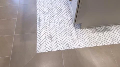Herringbone Tile Pattern Meets Smooth Tan Flooring Stock Photos