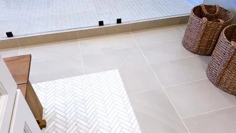 Herringbone Tile Pattern Meets Smooth Tan Flooring Stock Photos