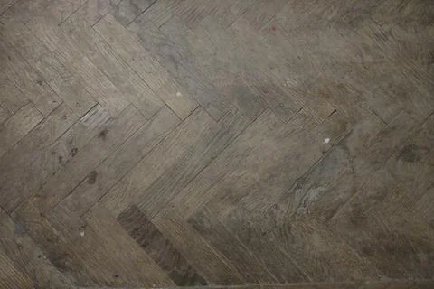 Herringbone wooden floor pattern inside an old building during the day Stock Photos
