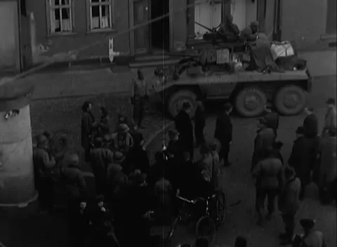 HERSFELD, GERMANY - 1945: Cobbled corner — Six-wheeled car draws Hersfeld crowd Stock Footage 348533082