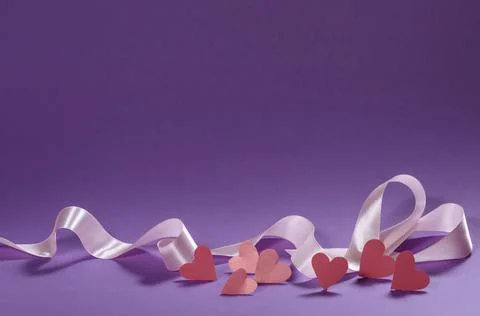 Herts with sequins on a violet background. Stock Photos