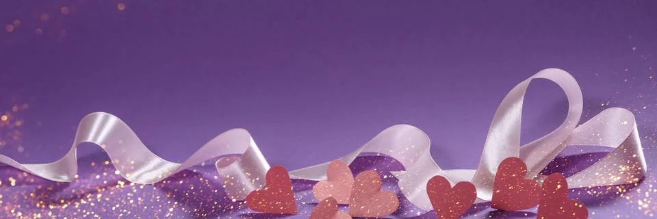 Herts with sequins on a violet background. Stock Photos