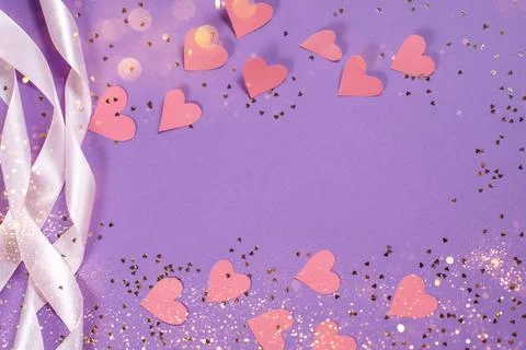 Herts with sequins on a violet background. Stock Photos